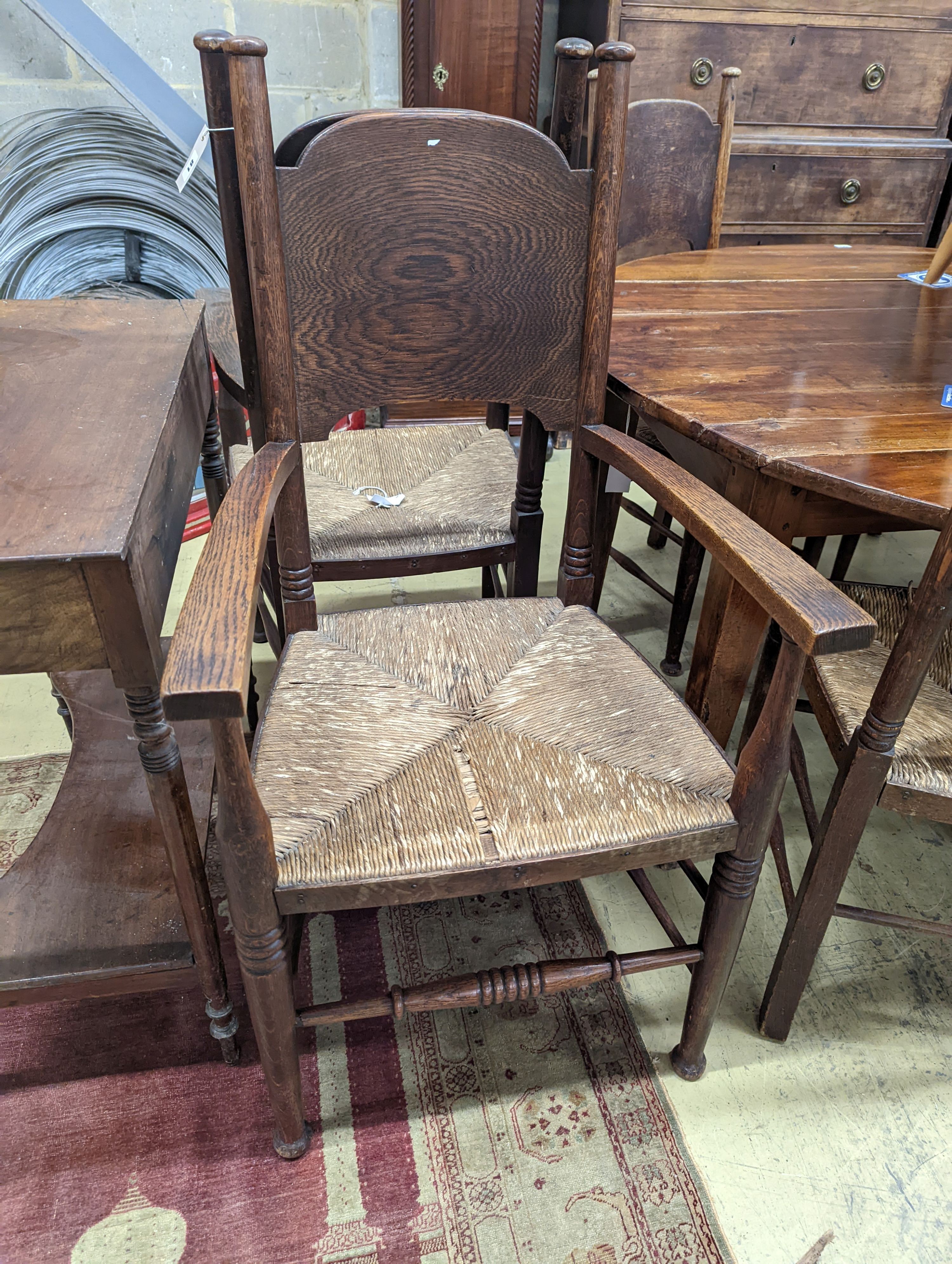 A set of six Arts & Crafts oak chairs, including a pair of carvers, in the Glasgow School manner by William Birch, High Wycombe, carvers W.58cm D.54cm H.109cm
